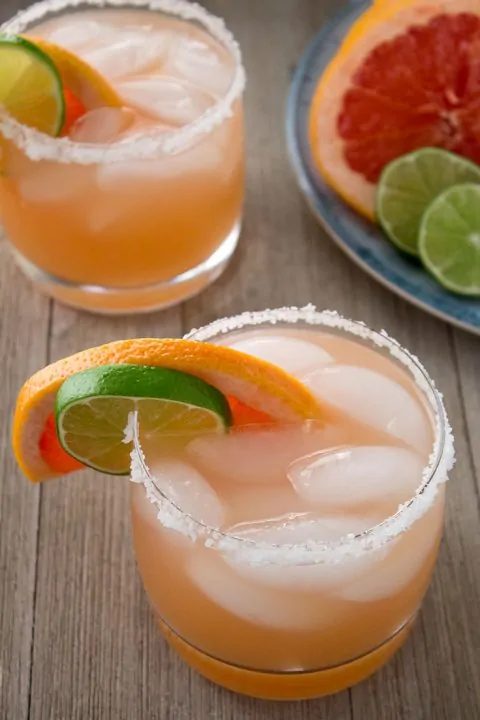 two grapefruit margaritas with salted rims