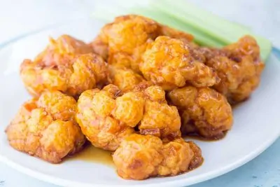 Air Fryer Cauliflower Wings on white plate with celery.