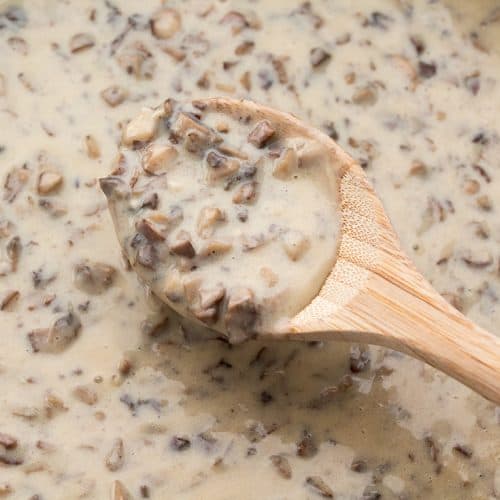 Vegan Cream of Mushroom Soup with a wooden spoon