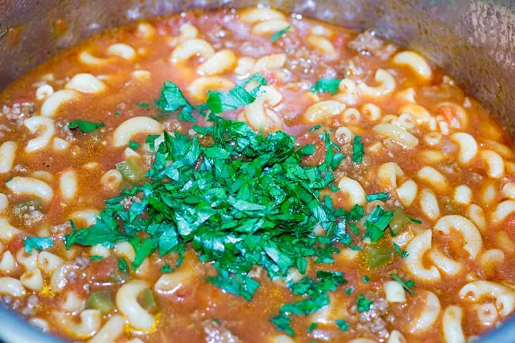 Pressure cooker goulash in Instant Pot topped with parsley.