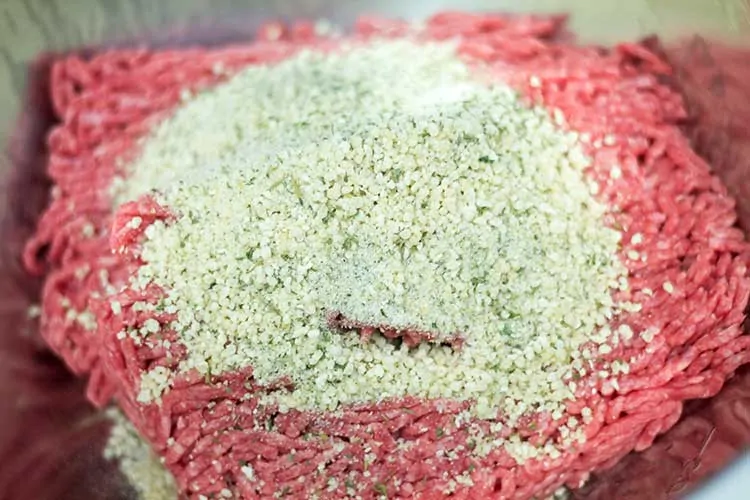 breadcrumbs and spices on top of ground beef