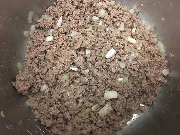 Browned ground beef and diced onions in Instant Pot.