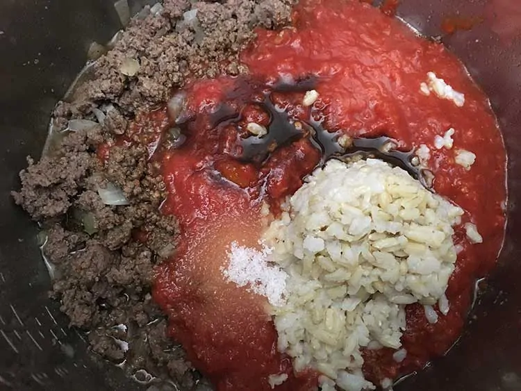 Browned beef topped with crushed tomatoes, rice, and Worcestershire.