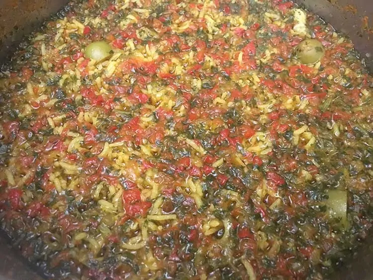 Cooked rice and sofrito in pot.