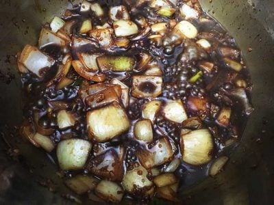 Pressure Cooker Oxtail Stew - sautéing onions and garlic in Worestershire | The Foodie Eats