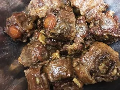 Pressure Cooker Oxtail Stew - fully cooked oxtails in mixing bowl | The Foodie Eats