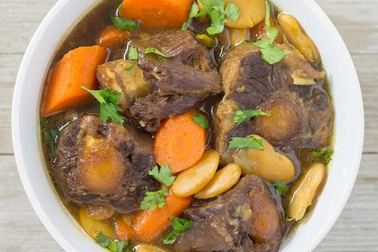 Pressure Cooker Oxtail Stew - overhead in white bowl | The Foodie Eats