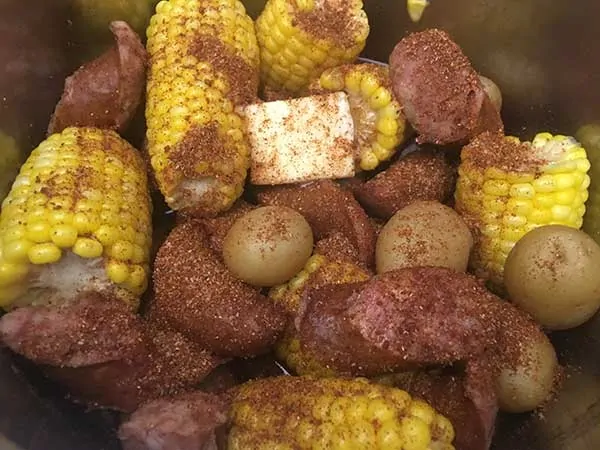 Corn, potatoes, sausage, and butter topped with spice blend.