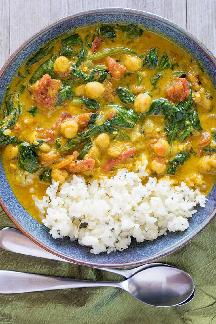 Bowl of Instant Pot Curry with Chickpeas with rice and spoons