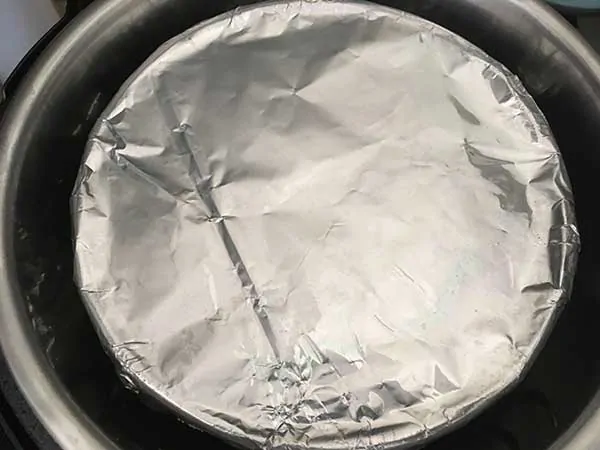 Push pan topped with aluminum foil in Instant Pot.
