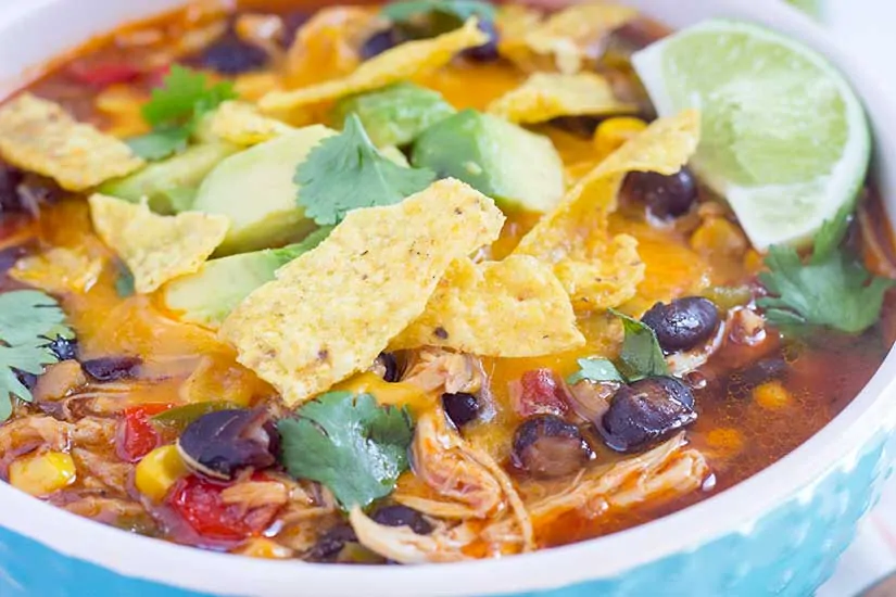 Instant Pot chicken tortilla soup in a teal bowl with white rim