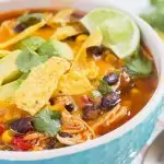 Instant Pot chicken tortilla soup in a teal bowl with white rim
