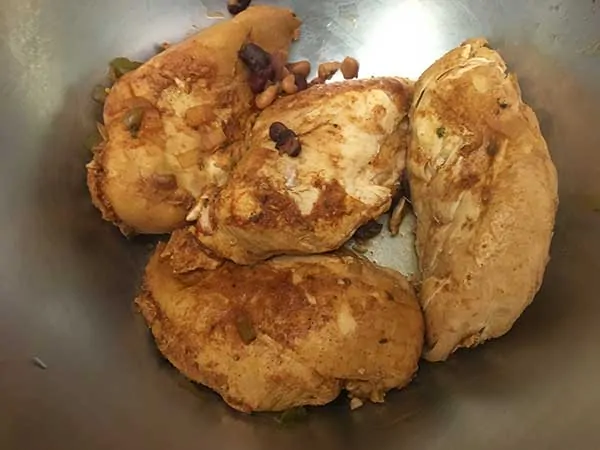 4 cooked chicken breast in a bowl.