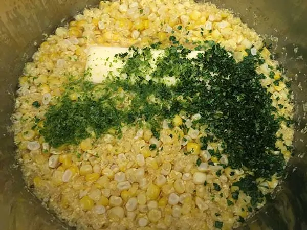 Cooked corn kernels with butter, lime zest and chopped cilantro.