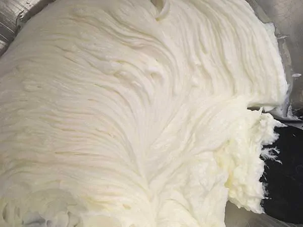 Whipped cream cheese in mixing bowl.
