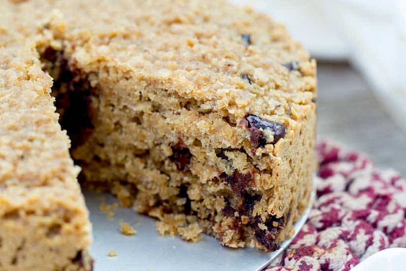 close up of baked oatmeal with chocolate chips on pan with piece missing