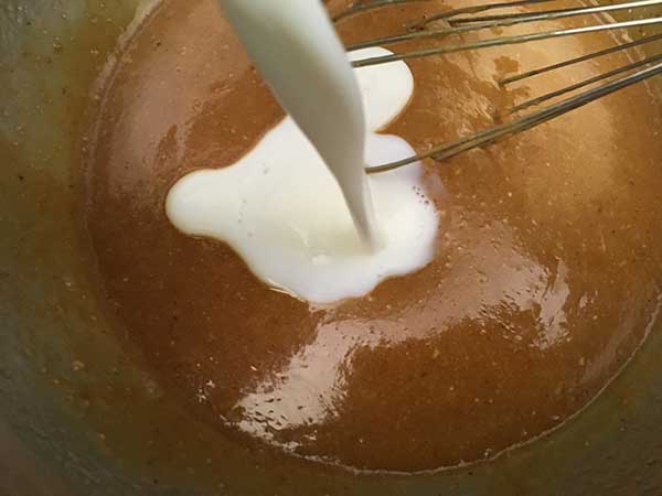 milk being poured into batter