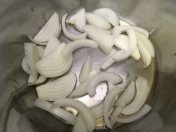 Onion slices cooking in bacon fat.