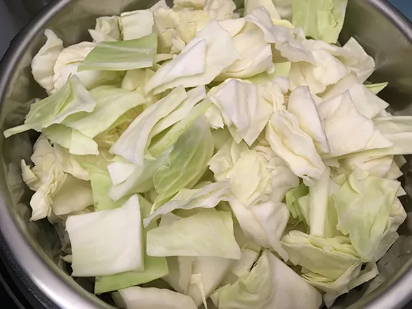 Instant Pot filled with chopped cabbage.