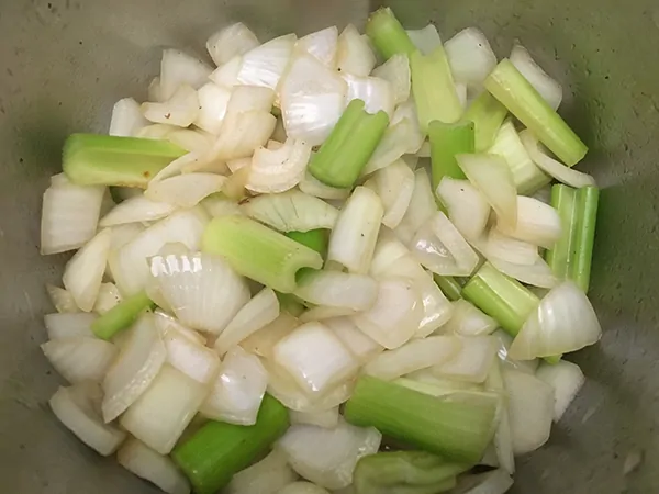 Chopped onions and celery sautéing in Instant Pot