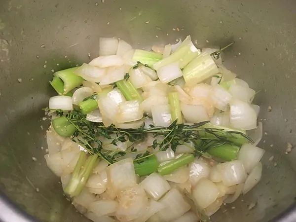 Chopped onions and celery sautéing in Instant Pot