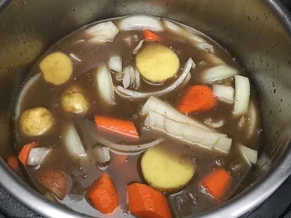 Potatoes, onions, and carrots in beef broth.
