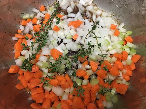 sautéing onions, carrots, celery, and thyme in Instant Pot