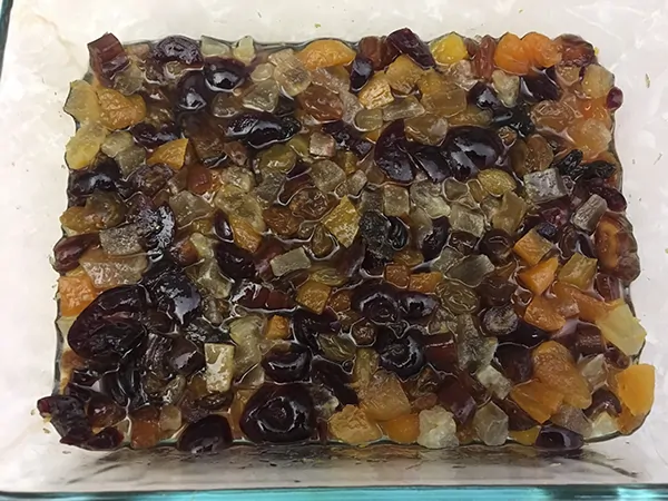 dried fruits soaking in Fireball whiskey in Pyrex dish