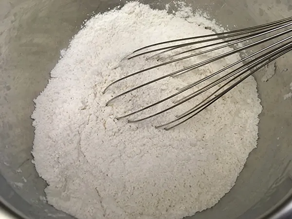 flour, salt, and baking powder in mixing bowl with whisk