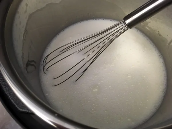 sugar and milk with whisk