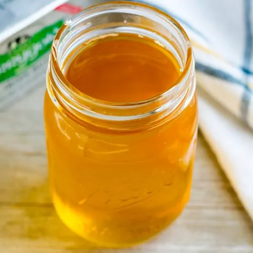 Liquid ghee with Kerrygold butter in background