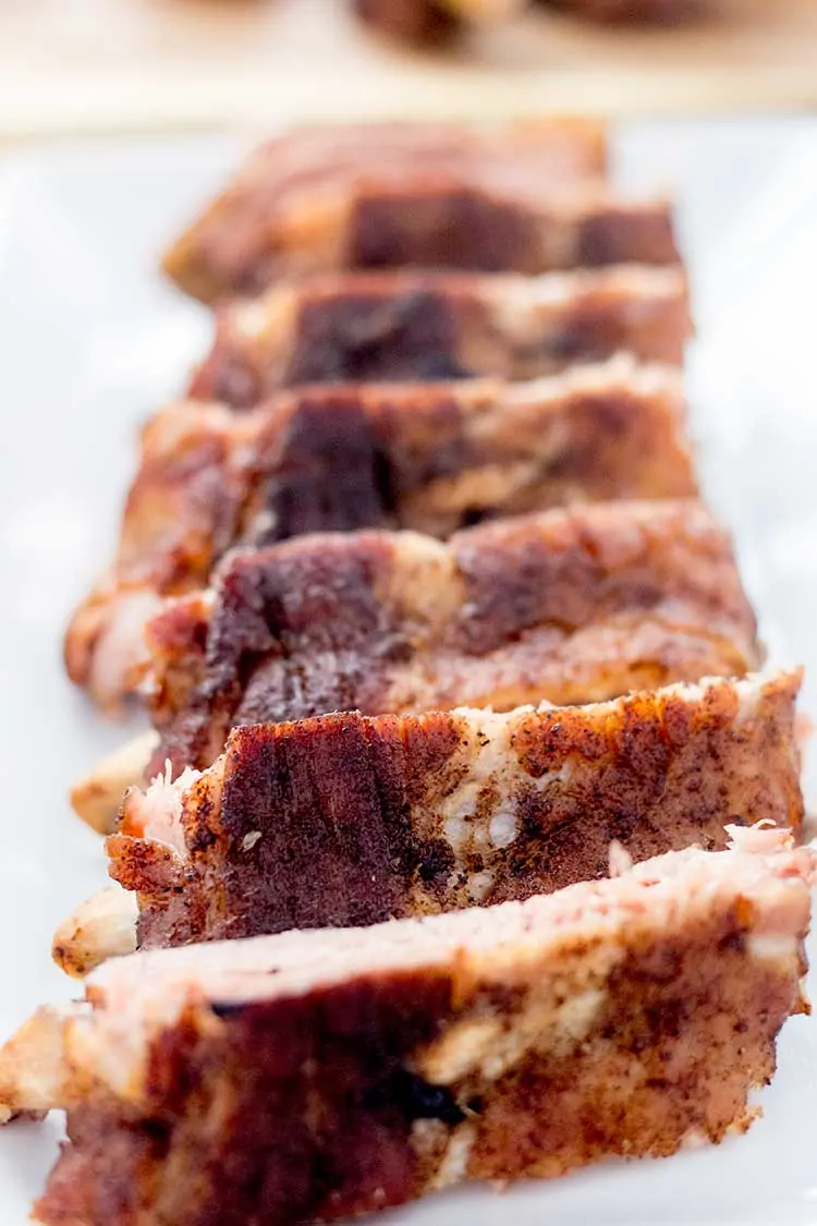 dry-rubbed sliced baby back ribs on white plate