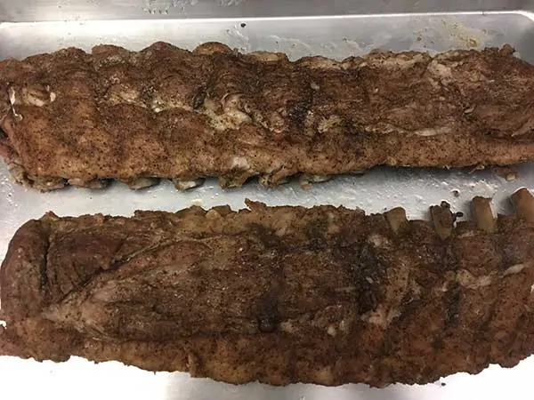 cooked baby back ribs on baking sheet
