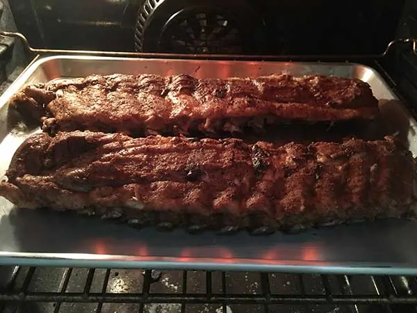 cooked ribs on baking sheet in oven