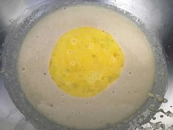 almond flour and chicken broth topped with eggs in mixing bowl