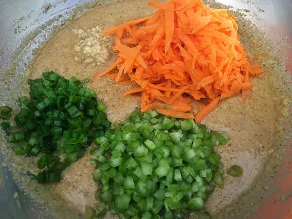 almond flour batter topped with carrots, celery, green onions and garlic