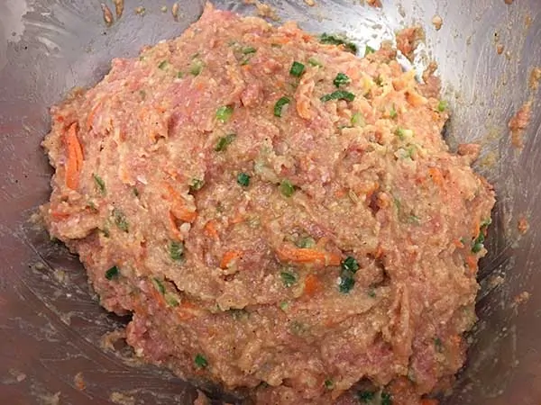 uncooked meatball mixture in mixing bowl
