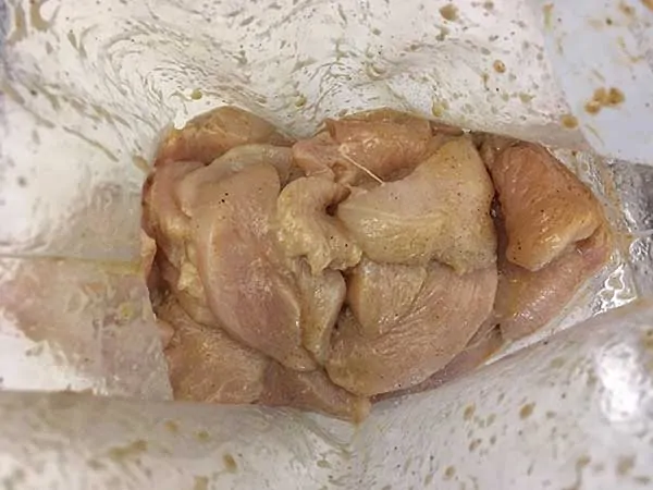 thinly sliced chicken marinating in Ziplock back