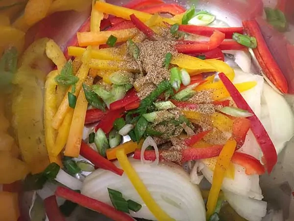 raw fajita vegetables topped with spices