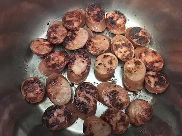 Sausage slices browning in Instant Pot.