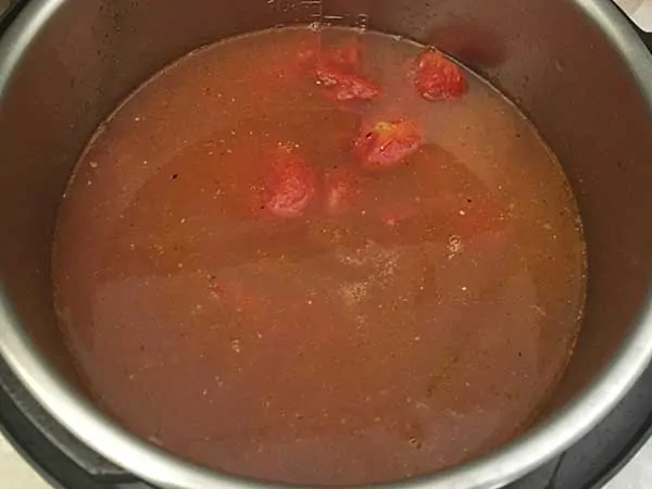 Chicken stock mixed with creole seasoning.