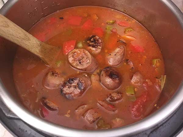 Sliced sausage in gumbo soup.