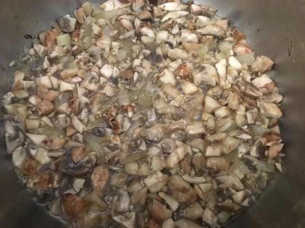 chopped mushrooms sautéing with minced garlic