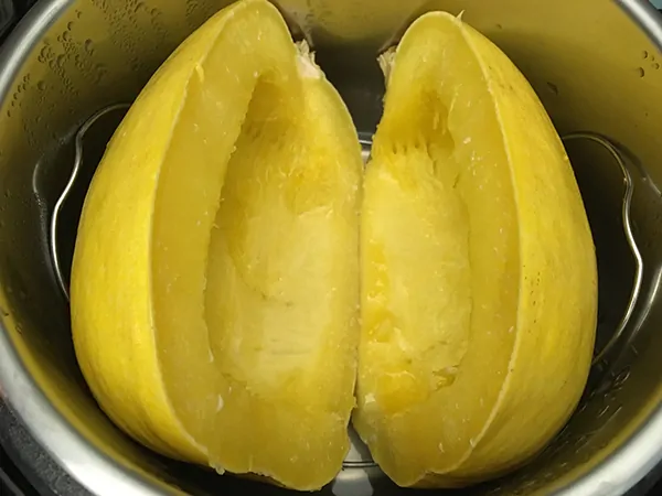 two cooked spaghetti squash halves in Instant Pot