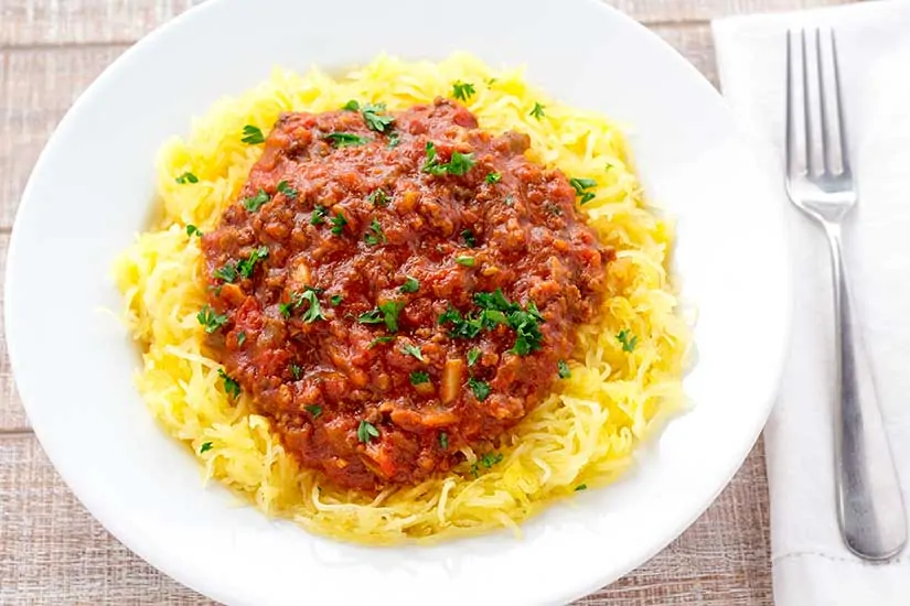 spaghetti squash and sauce in white bowl