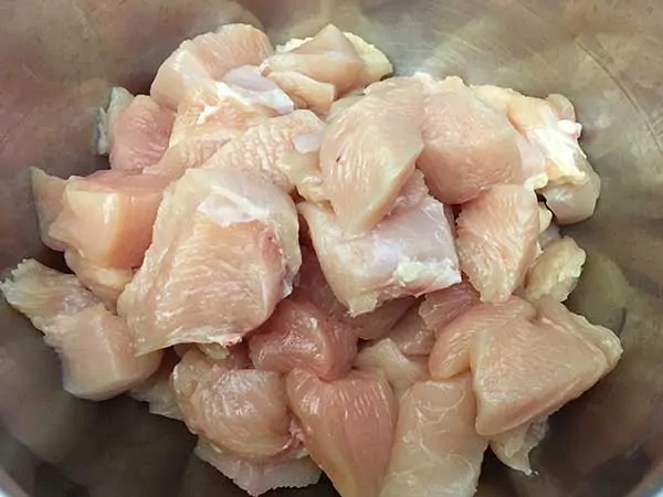 chunks of chicken breast in mixing bowl.