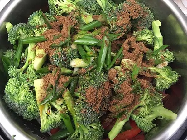 Chinese five spice on broccoli florets and green onions.