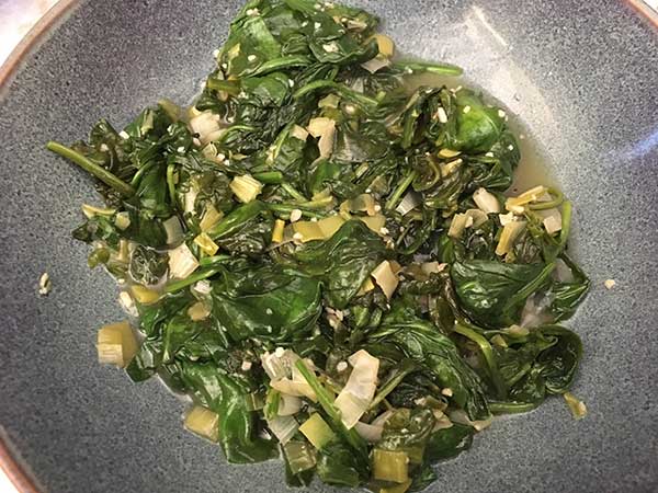 sautéed spinach in blue bowl
