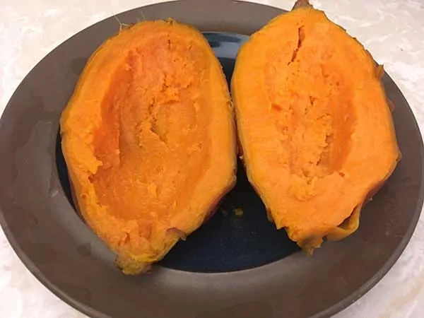 two sweet potato halves with center scooped out