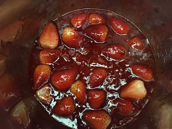 Halved strawberries covered in glaze.